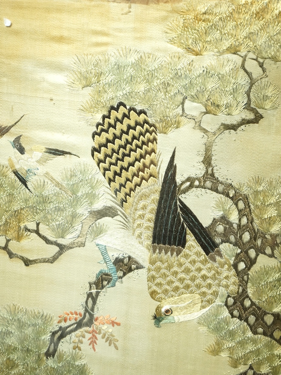A pair of Chinese embroidered ‘Hundred Bird’ silkwork pictures, c. 1900, in Hongmu and mother-of-pearl inlaid frames, total size 99cm x 32cm. Condition - dark staining and tears to the silk, losses to the mother of pearl